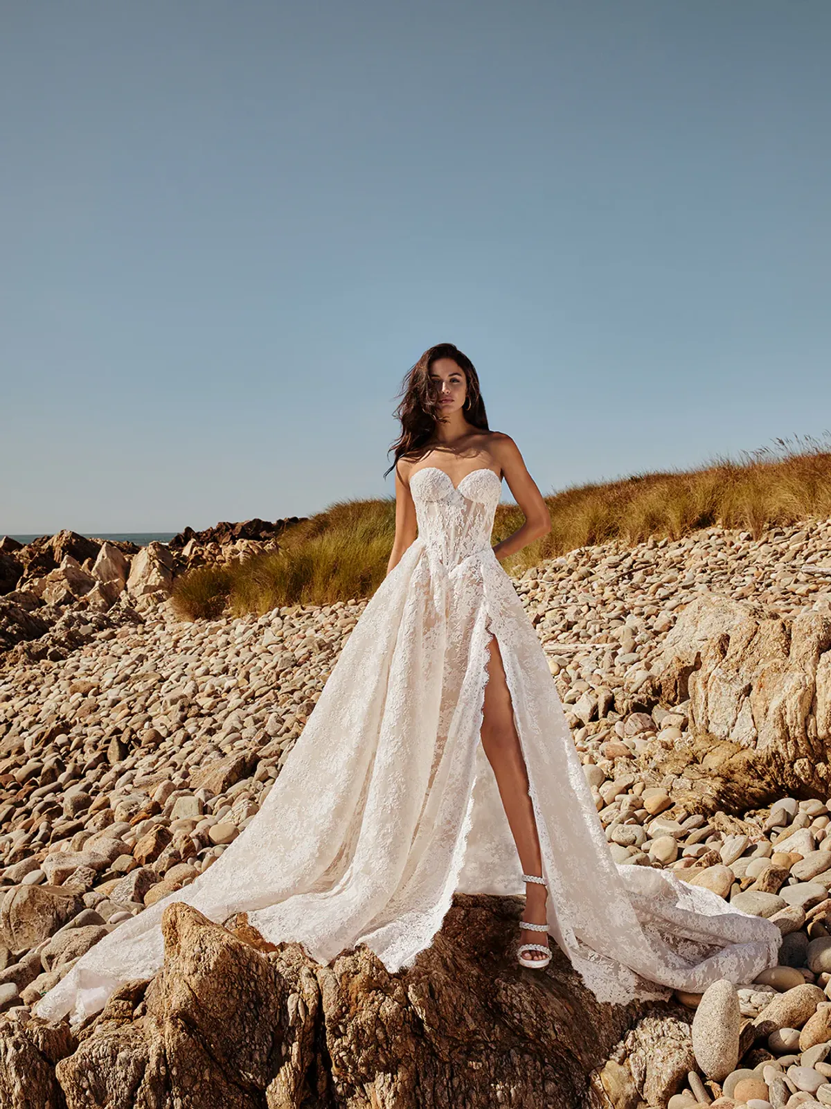 A model showcases the Galia Lahav Akira dress on a beach