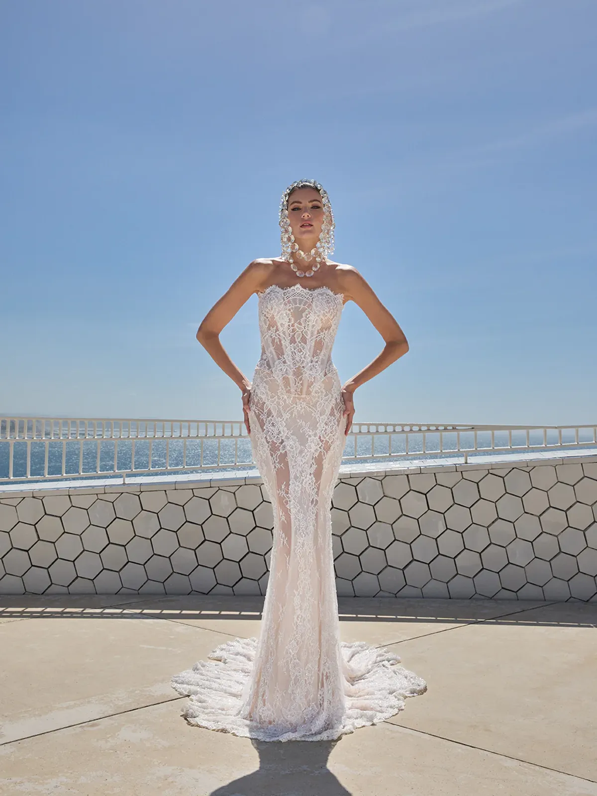 A model showcases the Galia Lahav Evangeline dress from the Couture collection in a modern room with white walls