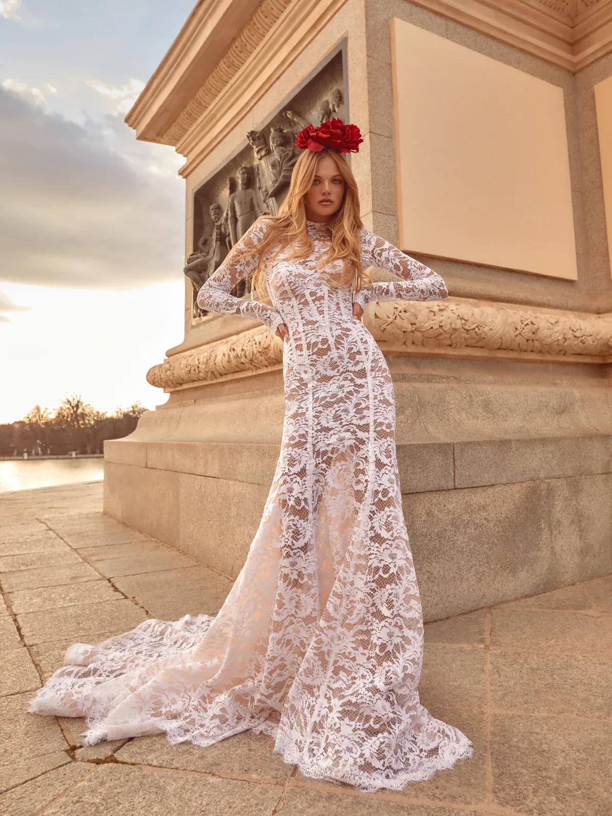 A model showcases the Galia Lahav Evita dress from the Couture collection in front of a stone column