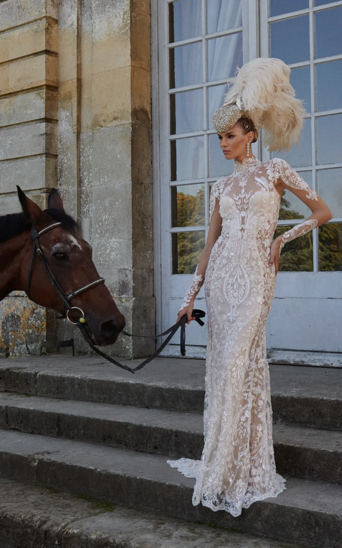 A model showcases the Galia Lahav Lafayette dress from the Couture collection while holding the reins for a horse