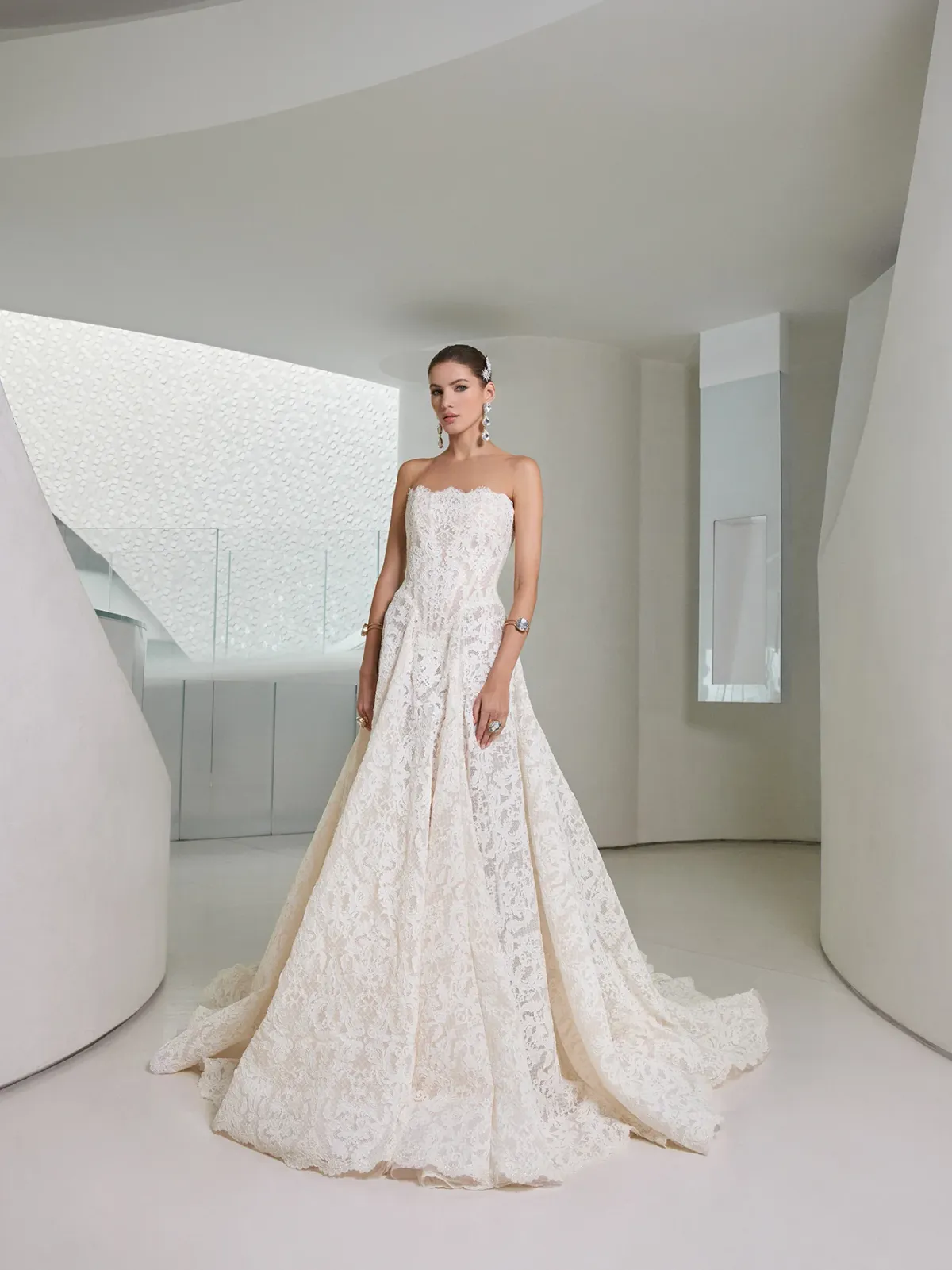A model showcases the Galia Lahav Splendid dress from the Couture collection outdoors on a patio