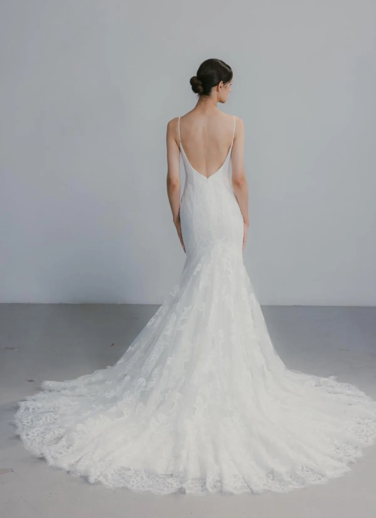 A model showcases the Beccar Valencia dress against a white backdrop