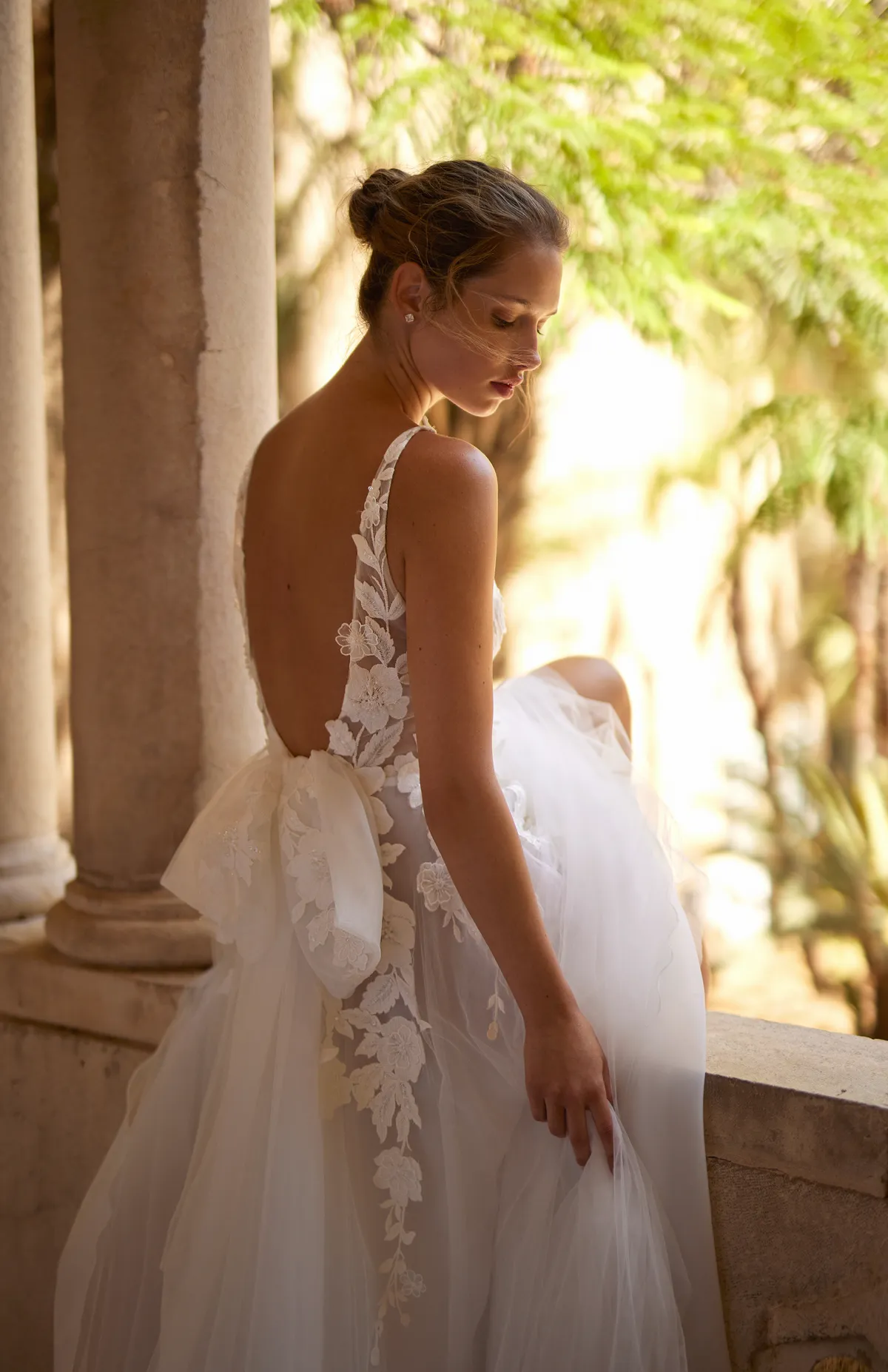 A model showcases the Arava Polak Ambre dress in front of a window