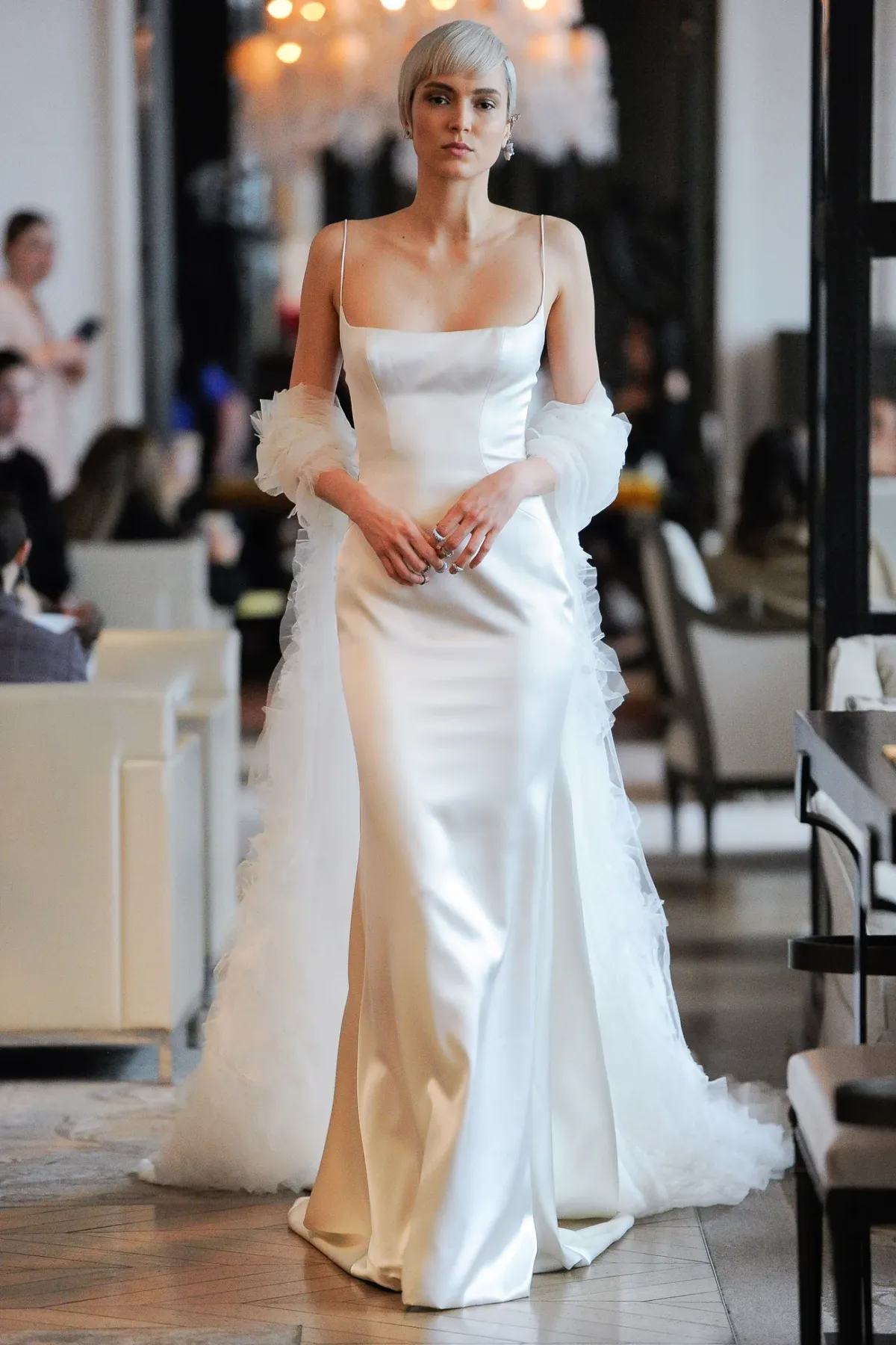 A model showcases the Ines Di Santo Robin dress from the Couture collection in a bridal shop