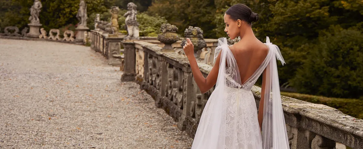 A model showcases an Ines Di Santo a-line dress featuring bows on the shoulder straps