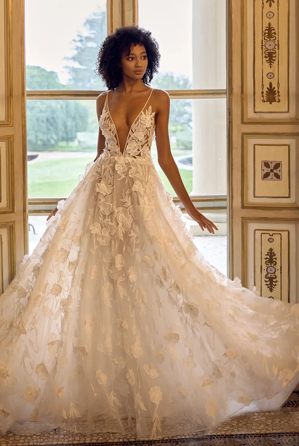 A model showcases the Ines Di Santo Lunette dress from the Ines by Ines Di Santo collection in front of a window