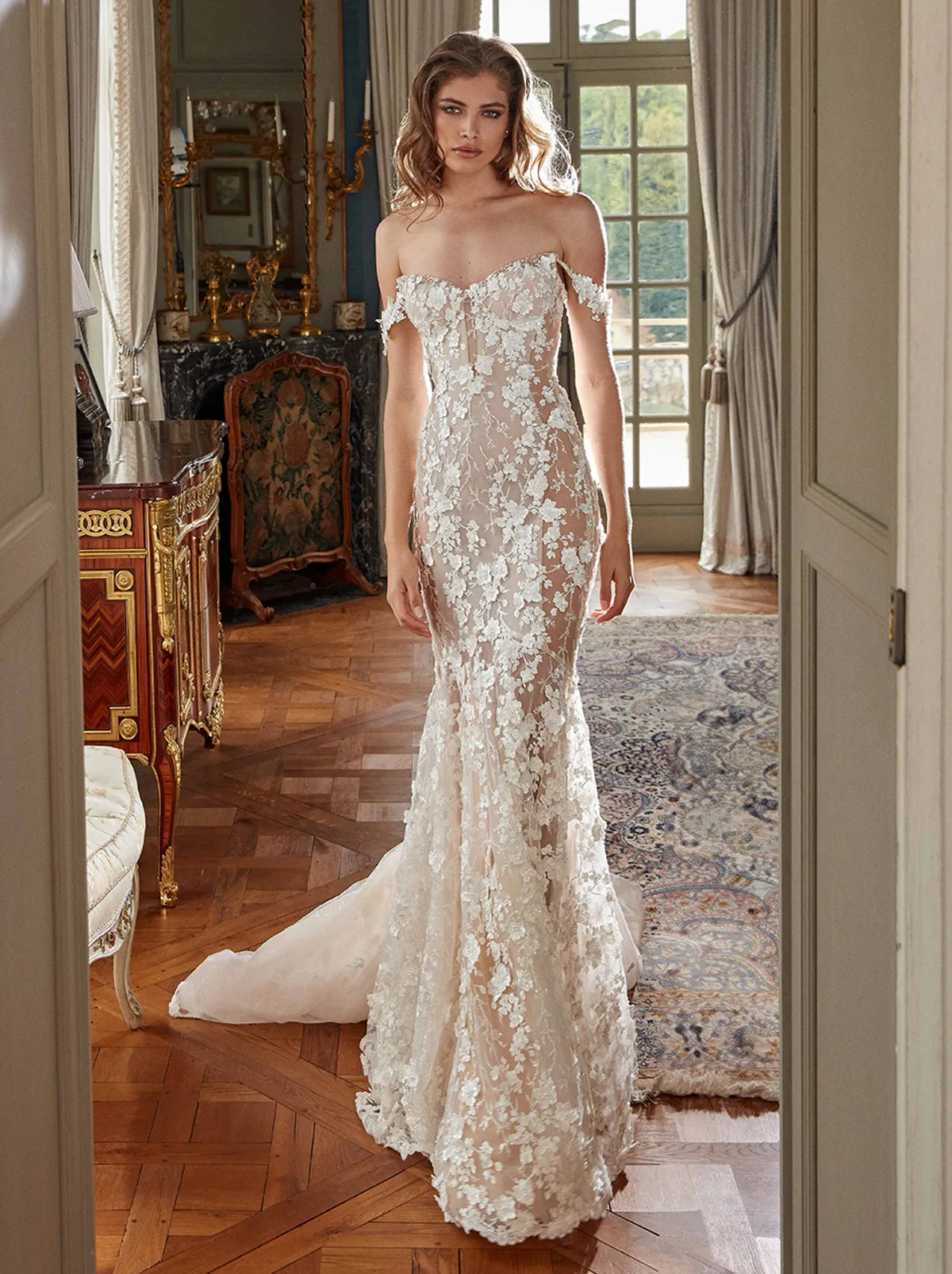 A model showcases the Galia Lahav Maya dress from the Couture collection inside a lavish mansion