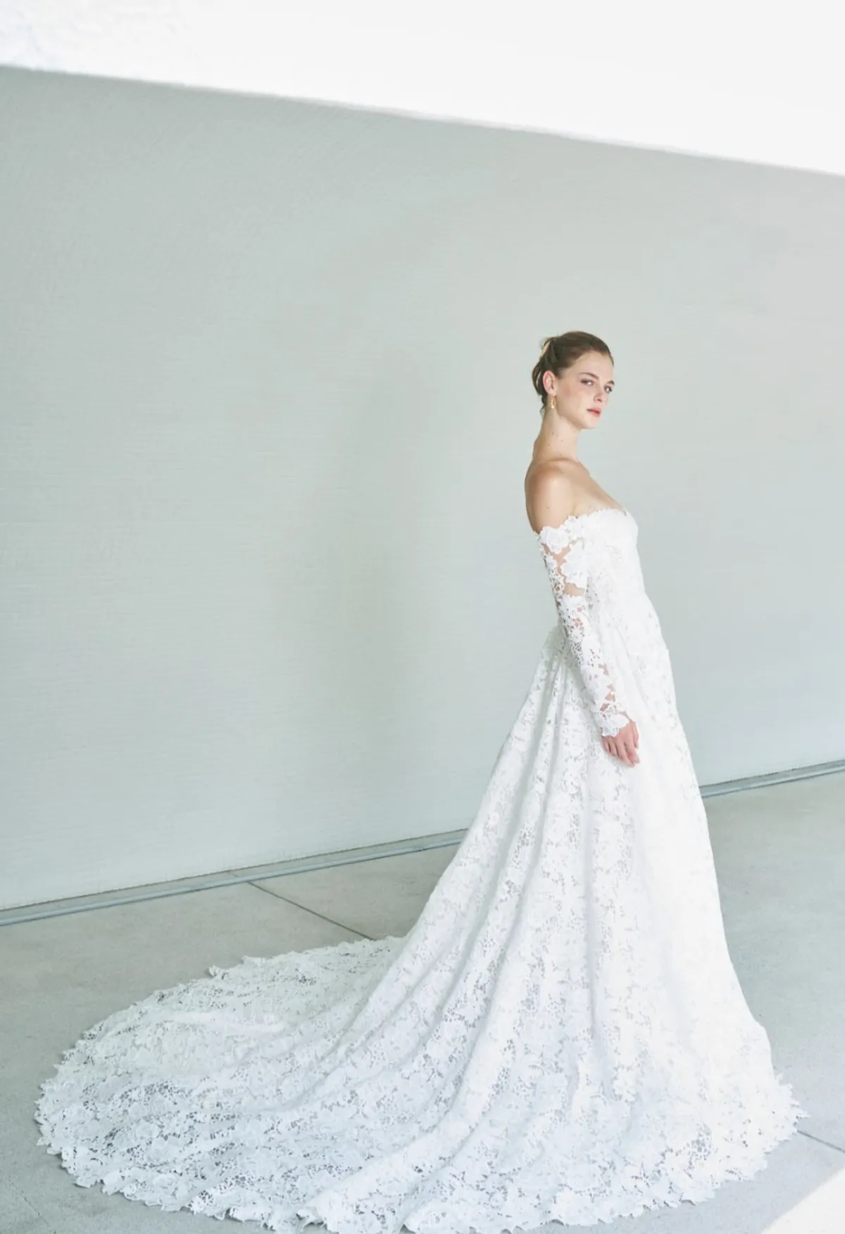 A model showcases the Beccar Shanti dress in a blue/grey room